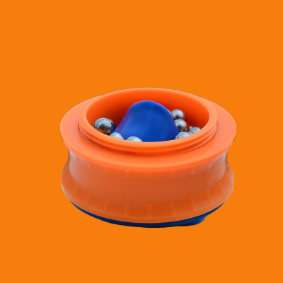 Orange and blue toy with small balls on an orange background